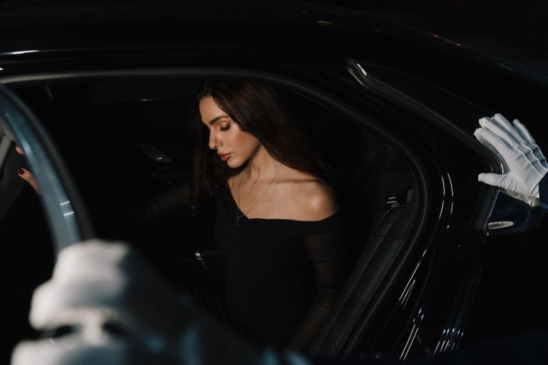 Chauffeur opening car door for passenger