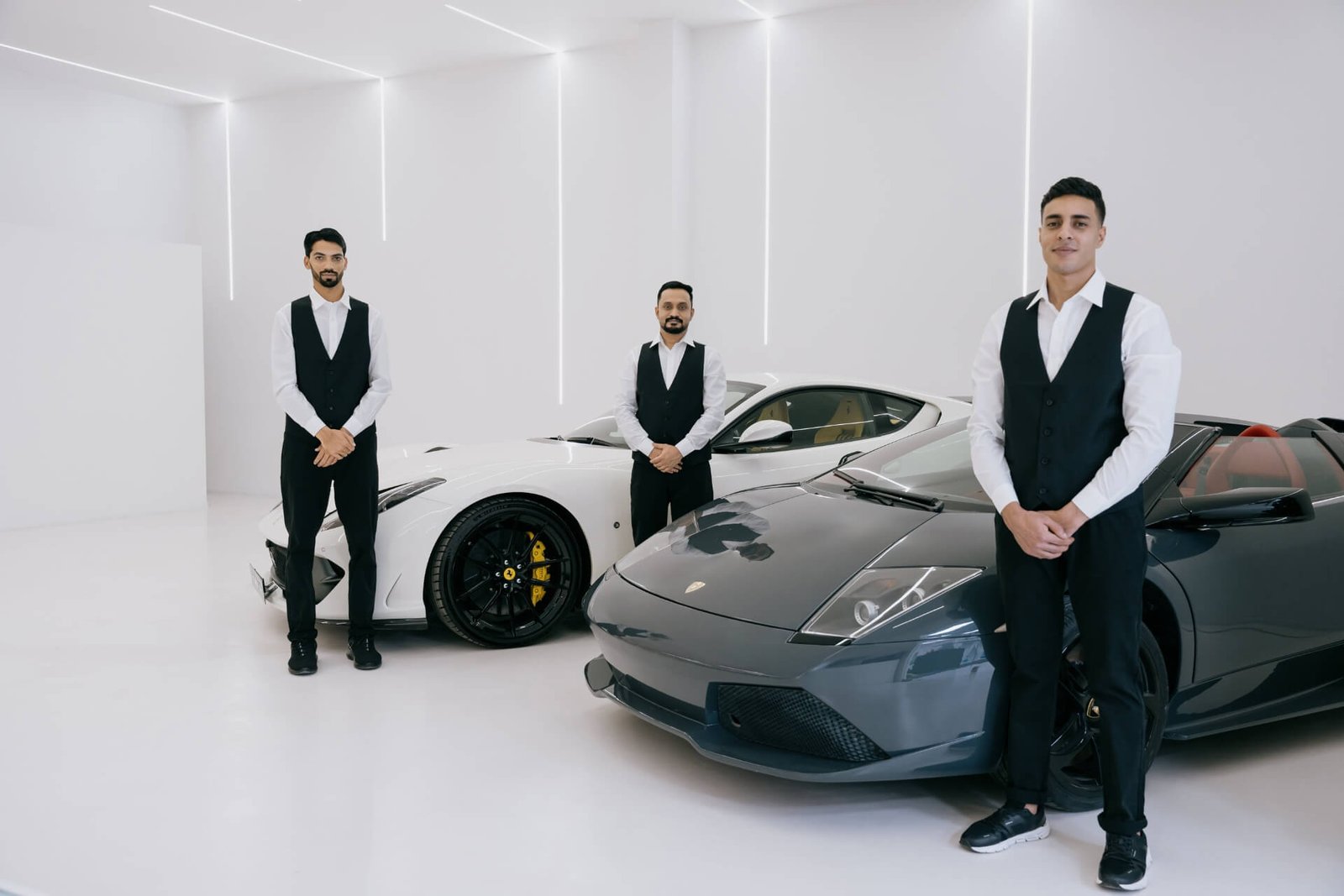 valet parking attendants standing with cars