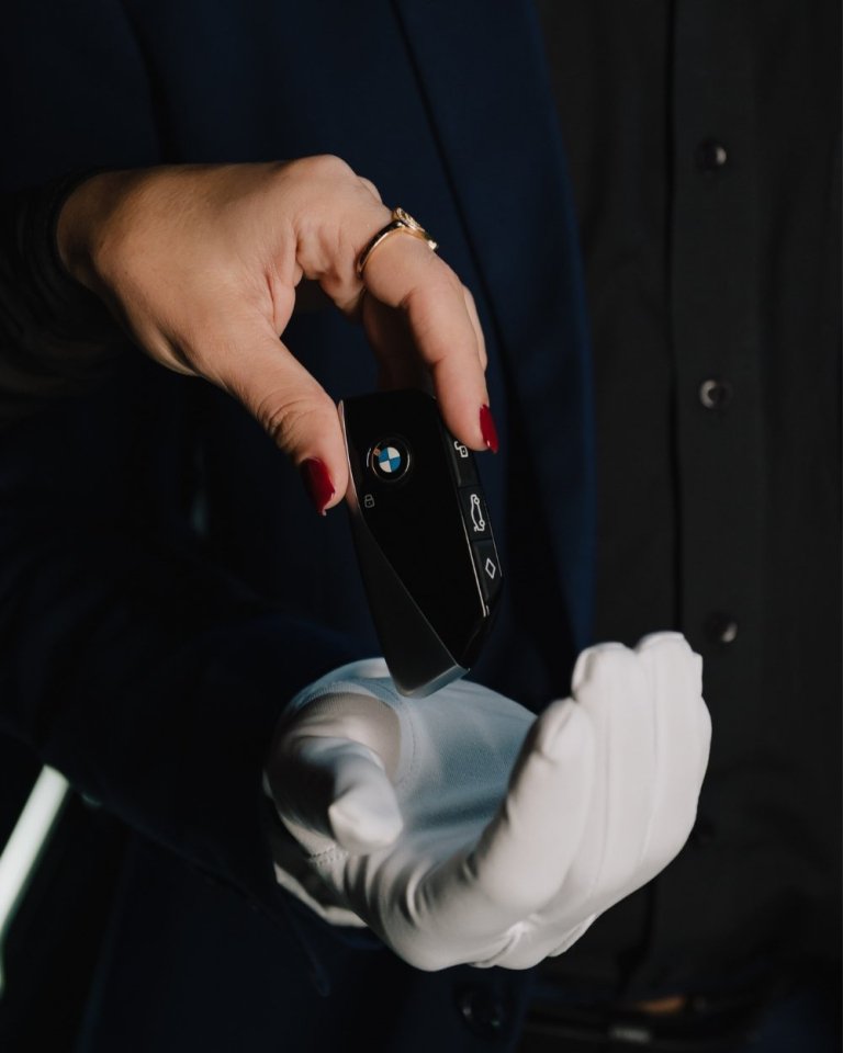 Valet parking manager receiving a car key
